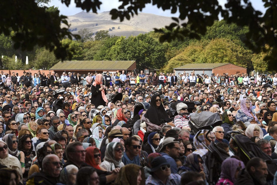 Members of the public look on during a gathering for congregational Friday prayers and two minutes of silence for victims of the twin mosque massacre, at Hagley Park in Christchurch. PHOTO: AFP