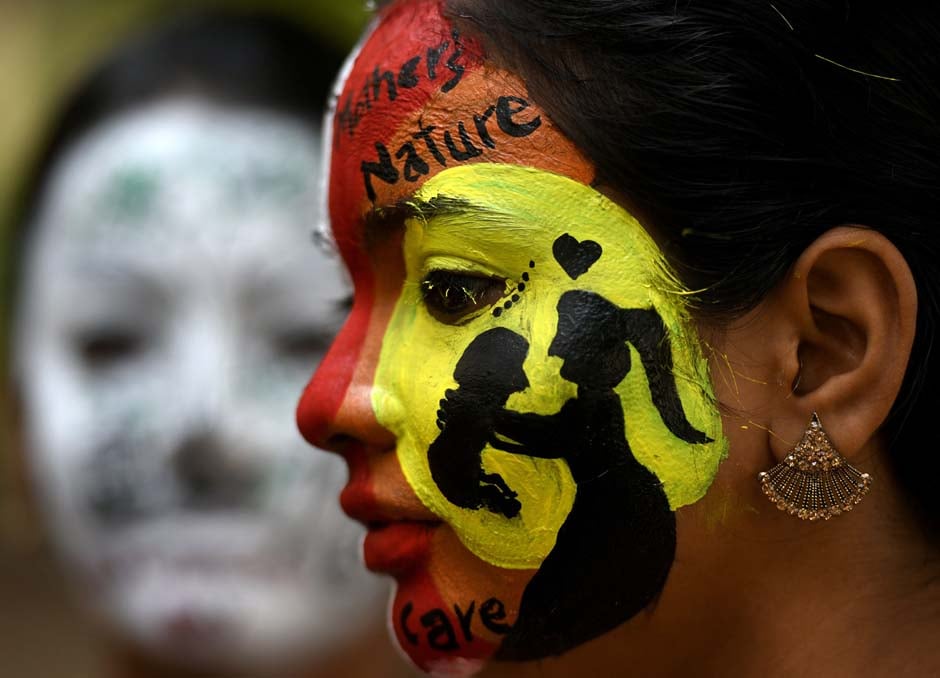 Indian students pose with their faces painted on the occasion of International Women's Day celebration at a college in Chennai. PHOTO: AFP