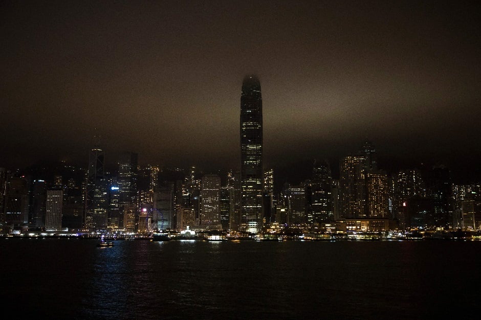 The Victoria Harbour is seen after its lights went out for the Earth Hour environmental campaign in Hong Kong on March 30, 2019. PHOTO: AFP
