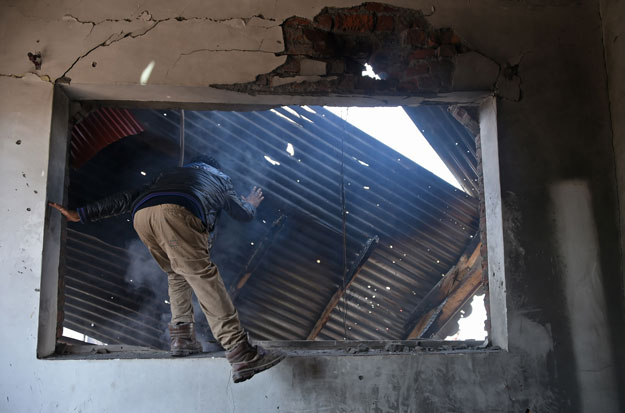 A Kashmiri villager looks at the remains of a house destroyed during a deadly gun battle between freedom fighters and Indian government forces in Hajin area, in Bandipora district of occupied Kashmir on March 22, 2019. PHOTO: AFP