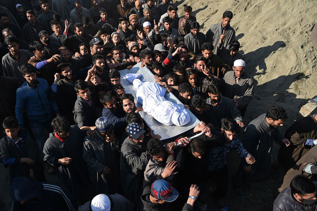 Kashmiri villagers carry a charred body of a twelve-year-old boy, Aatif Mir, during a funeral procession in Hajin area, in Bandipora district of occupied Kashmir on March 22, 2019. PHOTO: AFP