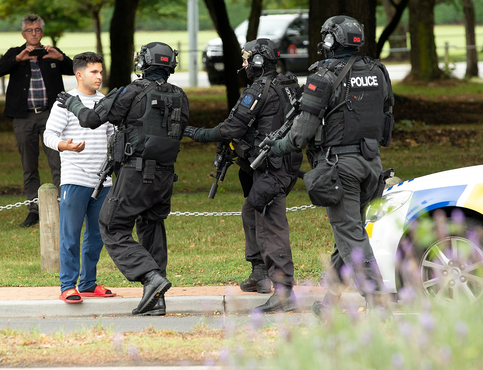 AOS (Armed Offenders Squad) push back members of the public following a shooting at the Masjid Al Noor mosque in Christchurch, New Zealand. PHOTO: REUTERS