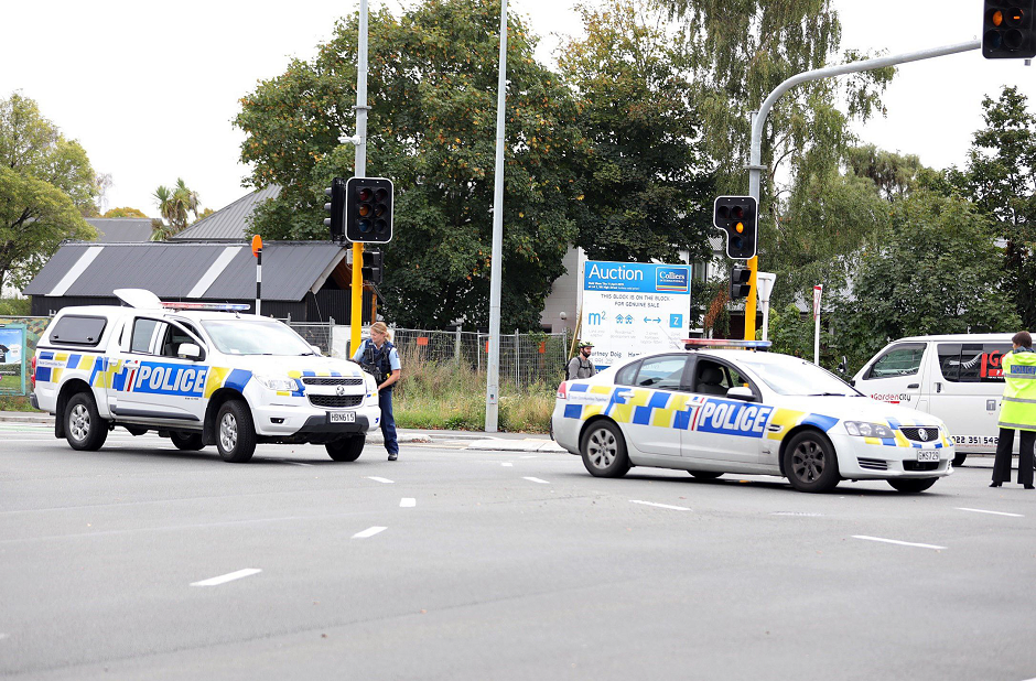 This picture released by Radio New Zealand shows police officers cordoning a street near the mosque after a firing incident in Christchurch. PHOTO: AFP