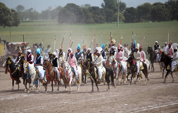 This photograph taken on March 27, 2019, shows Pakistani horse riders during an attempt for a Guinness World Record for tent pegging in Khanewal district in Punjab province. PHOTO: AFP