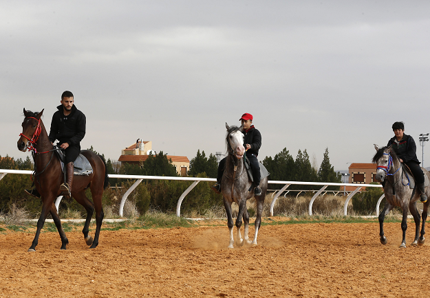 Syrian equestrians ride their horses at a track in the town of Dimas, west of the capital Damascus on December 5, 2018. PHOTO: AFP