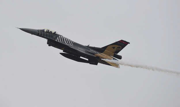 A Turkish pilot waves from the Turkish Air Force F-16 Fighting Falcon during the Pakistan Day parade in Islamabad on March 23, 2019. -PHOTO: AFP