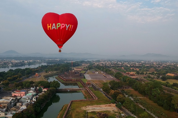This aerial photograph shows a hot air balloon flying over the the former capital's stone citadel during a hot air balloon festival in the central Vietnamese city of Hue on April 28, 2019. PHOTO: AFP