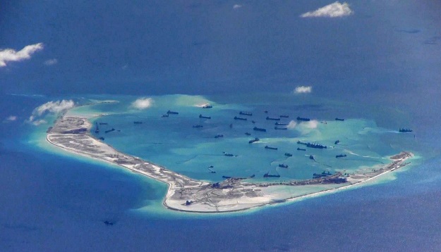 This still image, from video taken by an American P-8A Poseidon surveillance aircraft in 2015, purportedly shows Chinese dredging vessels around Mischief Reef in the disputed Spratly Islands in the South China Sea. PHOTO: REUTERS