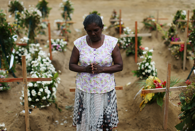 A man reacts during mass burials near St. Sebastian church in Negombo. PHOTO: REUTERS