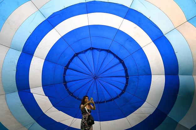 A woman takes a selfie inside a hot air balloon during a hot air balloon festival in the central Vietnamese city of Hue on April 28, 2019. PHOTO: AFP