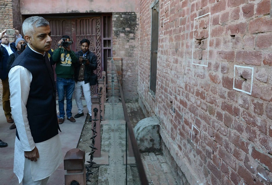 December 6, 2017: Mayor of London Sadiq Khan (L) looks at bullet marks on a wall during his visit at Jallianwala Bagh in Amritsar. PHOTO: AFP