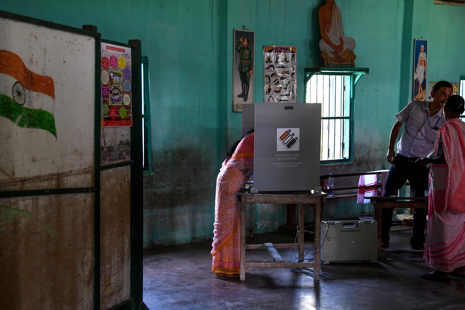 An Indian woman casts her vote at a polling station during India's general election in Salna Tea Estate, some 170 km from Guwahati, the capital city of India's northeastern state of Assam on April 11, 2019. PHOTO: AFP