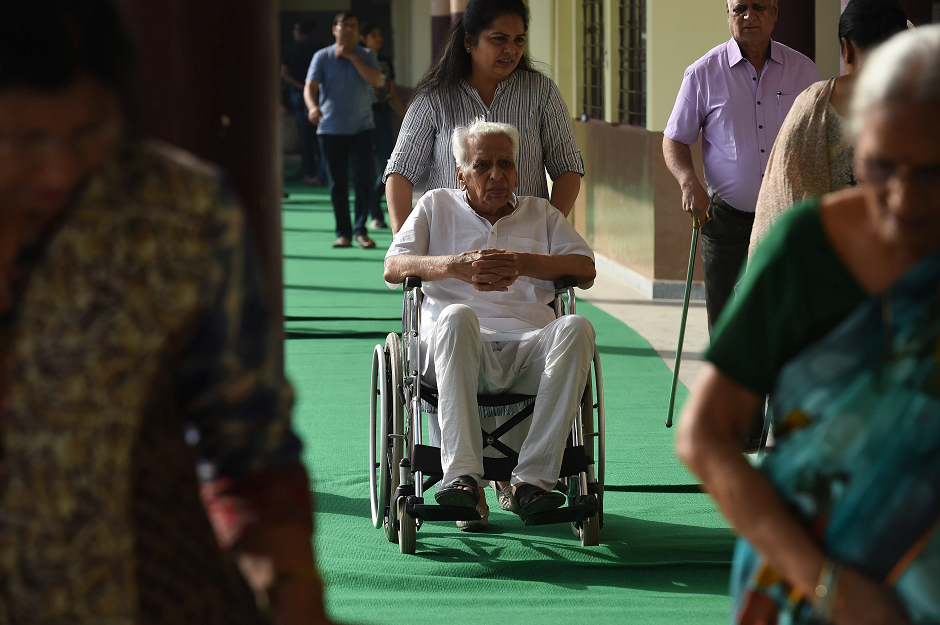 A man in a wheelchair arrives at a polling station to vote during India's general election in Ghaziabad, Uttar Pradesh on April 11, 2019. PHOTO: AFP