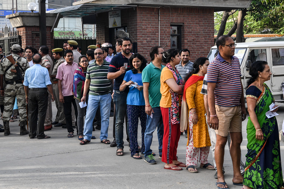 People line up to vote at a polling station during India's general election in Ghaziabad, Uttar Pradesh on April 11, 2019. PHOTO: AFP