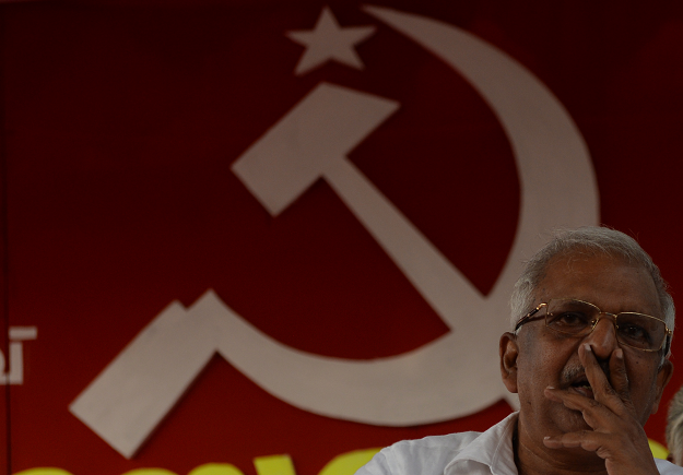 In this photo taken on April 19, 2019, P. Jayarajan, a Communist Party of India (Marxist) electoral candidate and who was a target of political violence in 1999, holds up his thumbless hand during an interview with AFP at Vadakara in the southern Indian state of Kerala. PHOTO: AFP