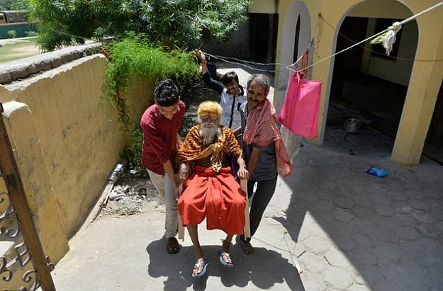 Indian priest Fakkad Baba, who will contest the upcoming elections for the national parliament, is carried by devotees in Mathura in Uttar Pradesh state. PHOTO: AFP