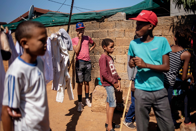 Children play in the yard of a dwelling in the coloured community of Eldorado Park on the outskirts of Johannesburg, on April 18, 2019. PHOTO: AFP