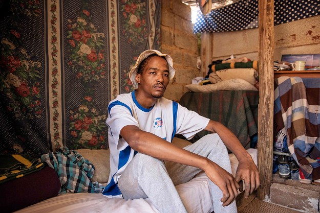 Chesney Van Wyk poses for a portrait inside the backyard dwelling he occupies in the coloured community of Eldorado Park on the outskirts of Johannesburg, on April 18, 2019. PHOTO: AFP