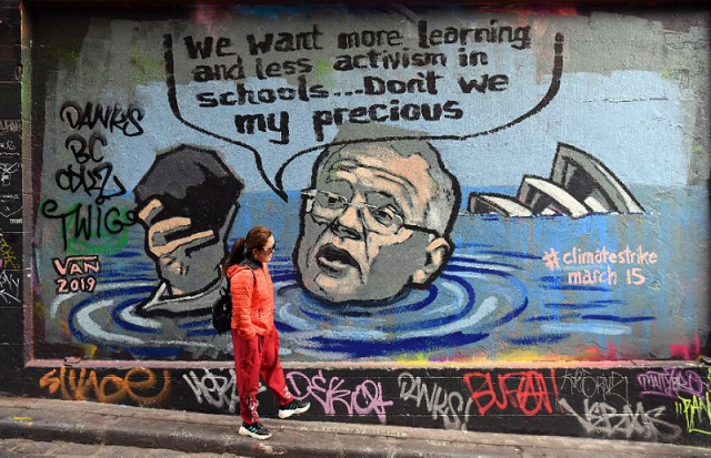 mural in melbourne shows australian prime minister scott morrison holding a lump of coal as it advertises a rally by students around the world to protest climate change photo afp