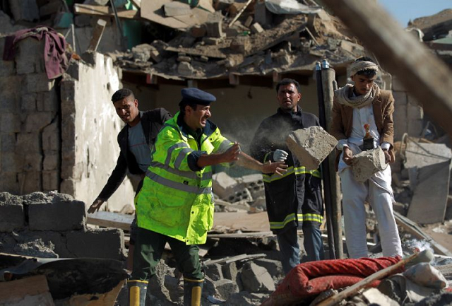 yemeni security forces look for survivors under the rubble of houses destroyed by saudi air strikes against huthi rebels near sanaa airport on march 26 2015 photo afp