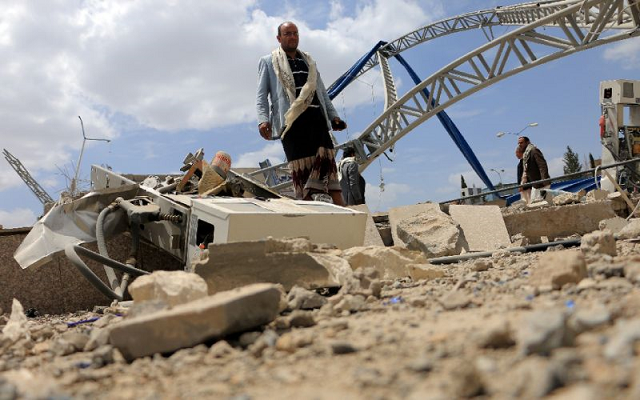 Men inspect a damaged petrol station after it was hit by a previous alleged Saudi-led coalition airstrike on the outskirts the Yemeni capital Sanaa on May 21, 2018. (PHOTO: AFP)