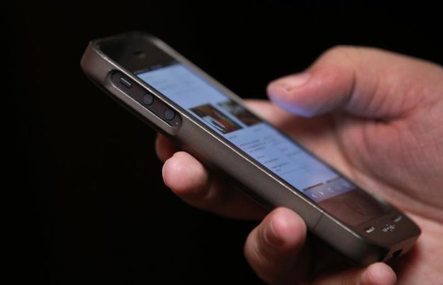 A man uses a smartphone. PHOTO: REUTERS