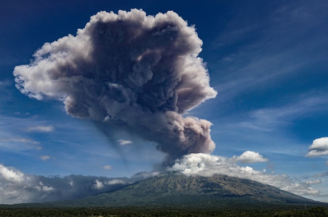 a plume of ash is released as mount agung volcano erupts seen from the kubu subdistrict in karangasem regency on indonesia 039 s resort island of bali on may 31 2019 photo afp