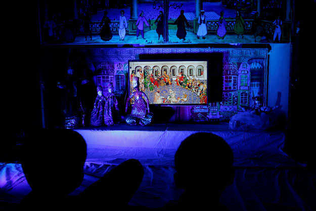 Children watch a string puppets play in a puppet theatre in Karachi, December 2, 2016. PHOTO: REUTERS/FILE