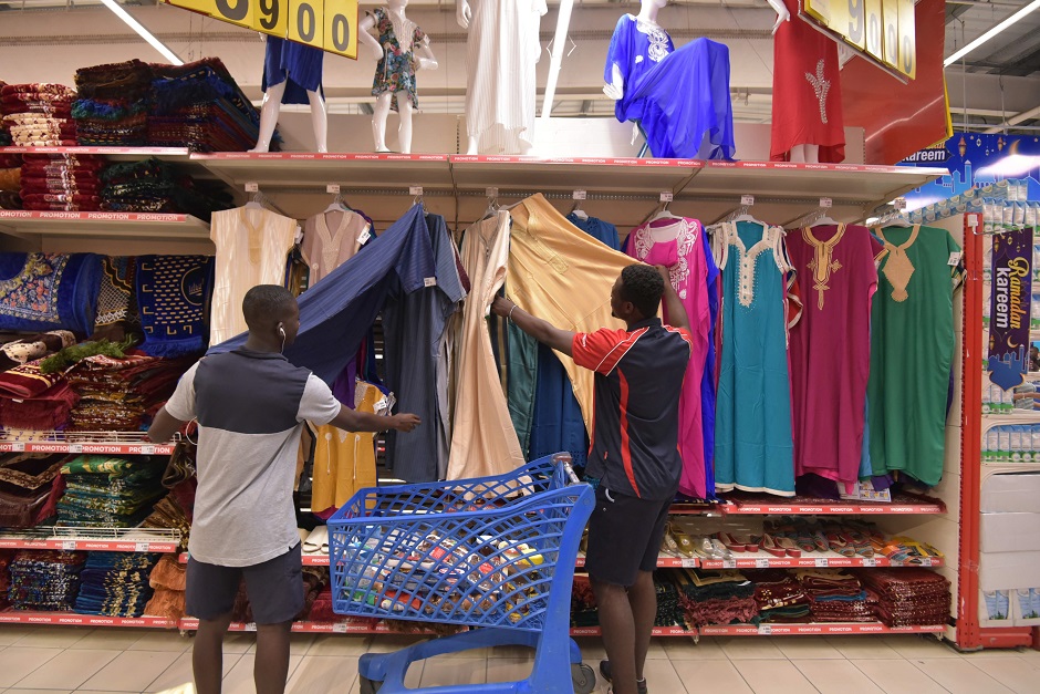 4.Men look at clothes at the Carrefour supermarket in Abidjan on May 4, 2019 on the eve of the start of the Ramadan, the Muslim holy month of fasting. PHOTO: AFP
