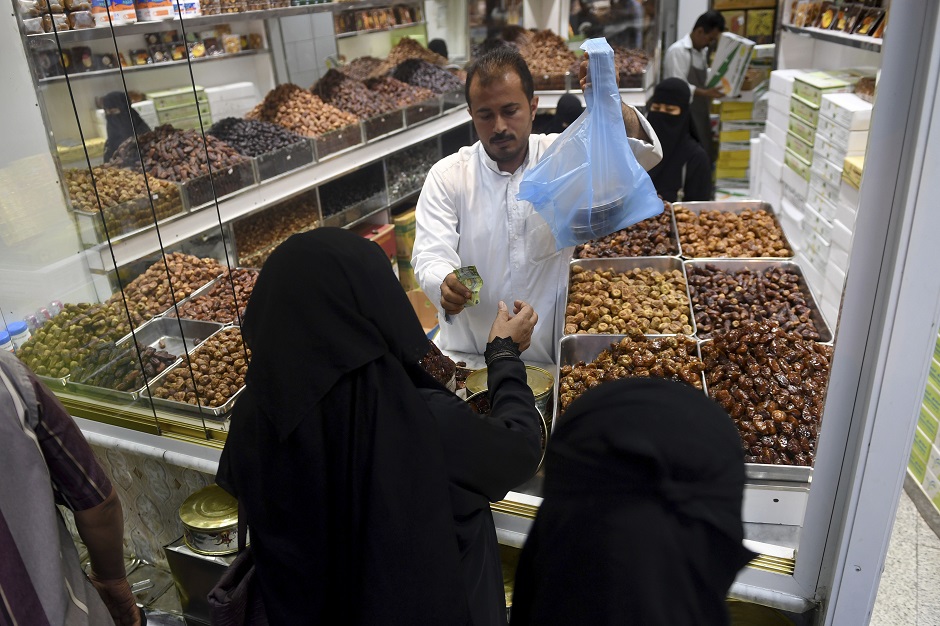 8.Saudi women shop for dried dates in the Saudi coastal city of Jeddah ahead of the Muslim holy fasting month of Ramadan. PHOTO: AFP