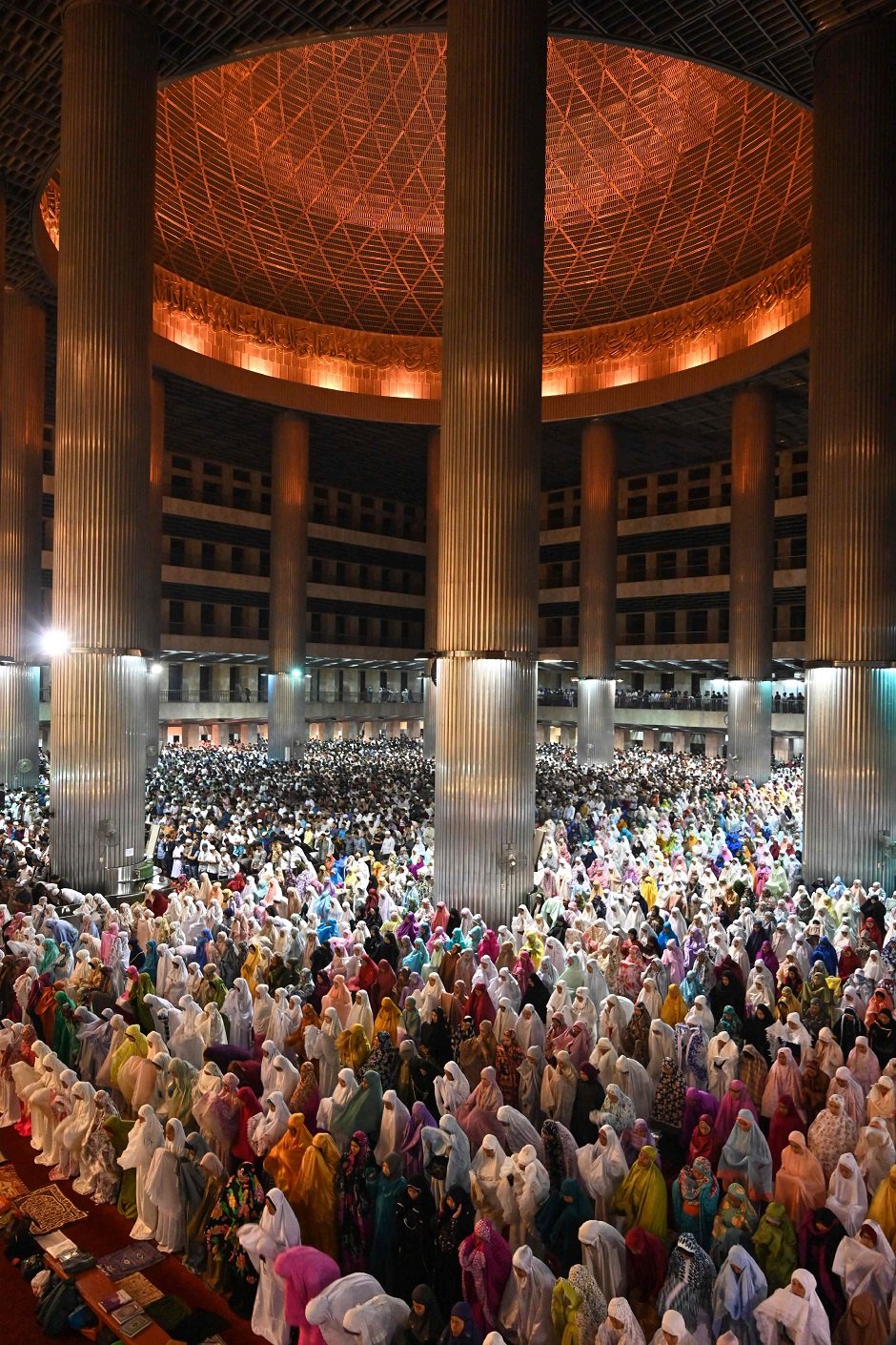 3.Muslim people pray on the first night of the holy month of Ramadan at the Istiqlal Grand Mosque in Jakarta, Indonesia. PHOTO: AFP