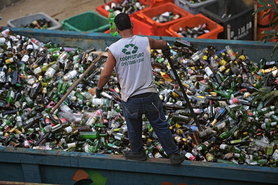A worker crushes glass bottles at CoopFuturo, a sorting collective which receives rubbish from the local government collection service and then sells the material to specialized recycling companies, in Rio de Janeiro, Brazil. PHOTO: AFP