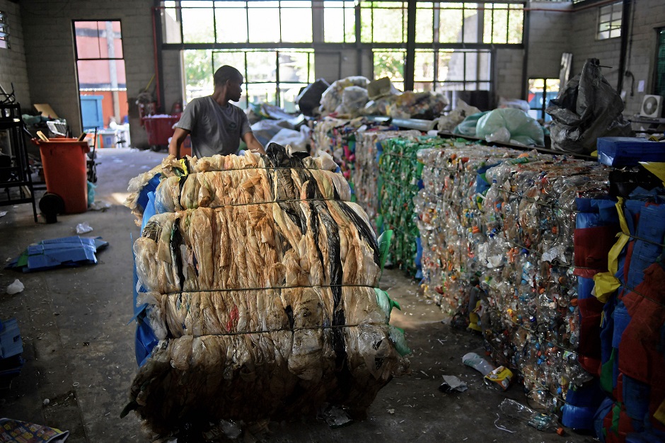 A men works in the recycling of plastic bags at CoopFuturo, a sorting collective which receives rubbish from the local government collection service and then sells the material to specialized recycling companies, in Rio de Janeiro, Brazil. PHOTO: AFP