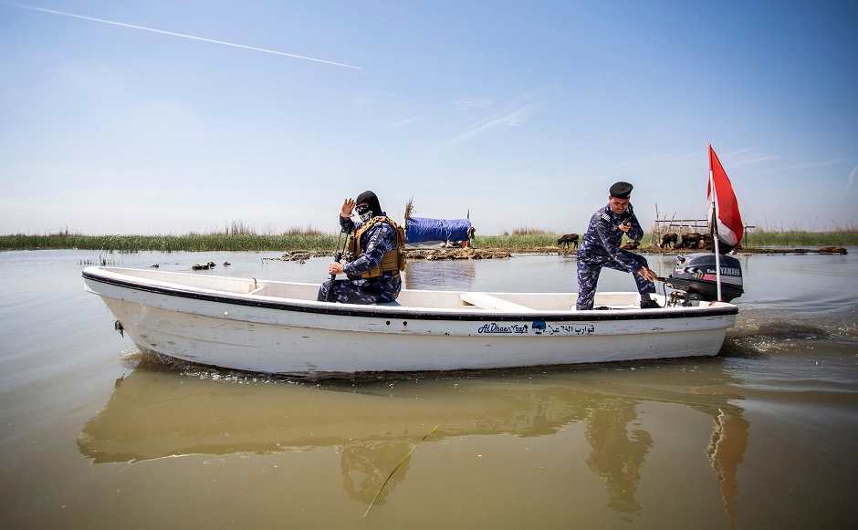 Members of the Iraqi security forces ride in and navigate a motorboat in the marshes of the southern district of Chibayish in Dhi Qar province, about 120 kilometres northwest of the southern city of Basra. PHOTO: AFP