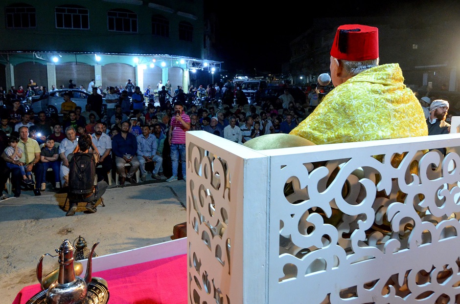 Traditional storyteller Abdel Wahed Ismail (on stage), entertains an audience in the northern Iraqi city of Mosul. PHOTO: AFP