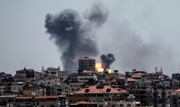 Smoke billows over Gaza City after Israel carries out an air strike in response to a barrage of rockets fired by Palestinian militants. PHOTO: AFP