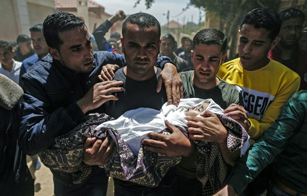 Palestinian mourners carry the shrouded body of Saba Abu Arar during her funeral in Gaza City on May 5, 2019. PHOTO: AFP