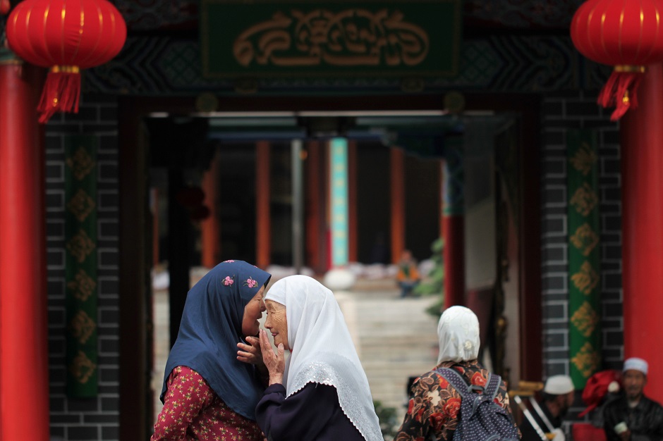 Muslim women chat outside a mosque before the holy fasting month of Ramadan, in Kunming, Yunnan province, China. PHOTO: REUTERS