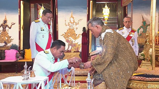 Thailandâs King Maha Vajiralongkorn with Thailandâs Prime Minister Prayut Chan-o-Cha during the annointment ceremony of his royal coronation in Bangkok. PHOTO: AFP