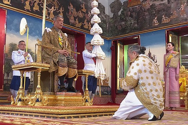 Thailand's King Maha Vajiralongkorn (2nd L) and Queen Suthida (R) with Chief Brahmin Phra Ratcha Khru Vamadeb Muni during the annointment ceremony of the royal coronation in Bangkok. PHOTO: AFP