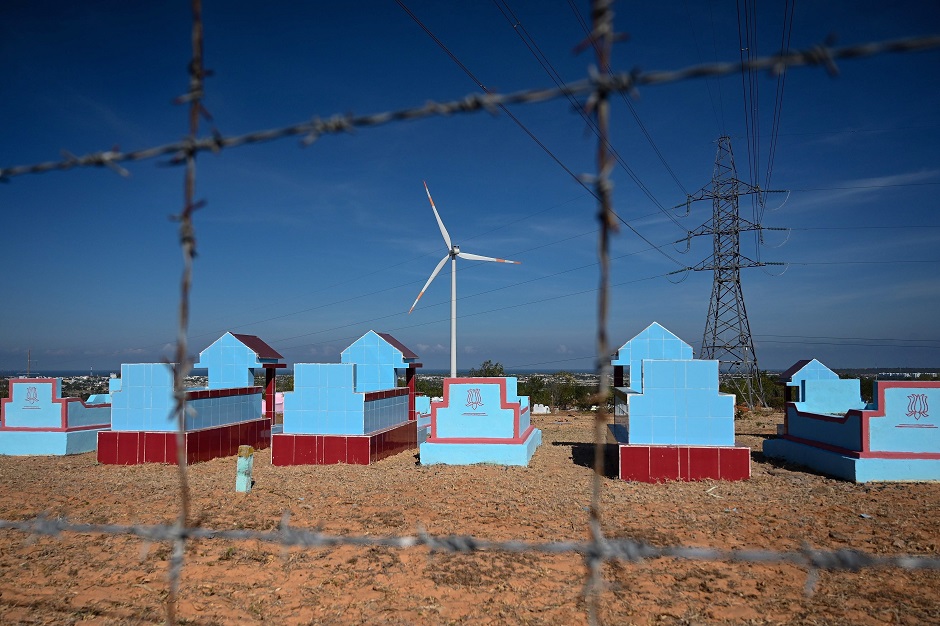 A wind turbine built on the grounds of a cemetery at the Phu Lac wind farm in southern Vietnam's Binh Thuan province. PHOTO: AFP