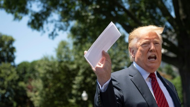 us president donald trump shows reporters a piece of paper that he said contained details of tough new concessions that he had extracted from mexico on the migration issue photo afp