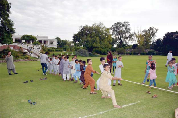 Orphans enjoy tug-of-war on the ground of the Khyber-Pakhtunkhwa (K-P) Governor House on Tuesday as part of Eid festivities. PHOTO: EXPRESS