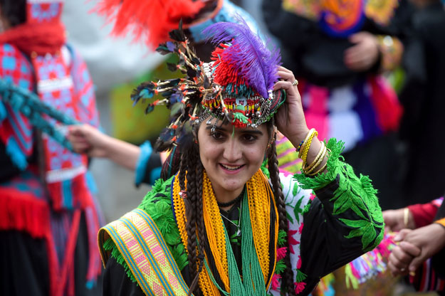 In this picture taken on May 16, 2019, Kalash women wearing traditional dresses dance as they celebrate 'Joshi', a festival to welcome the arrival of spring, at Bumburate village in the mountainous valleys in northern Pakistan. PHOTO: AFP