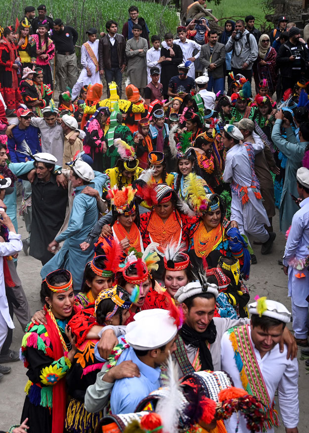 In this picture taken on May 16, 2019, Kalash women wearing traditional dresses dance as they celebrate 'Joshi', a festival to welcome the arrival of spring, at Bumburate village in the mountainous valleys in northern Pakistan. PHOTO: AFP