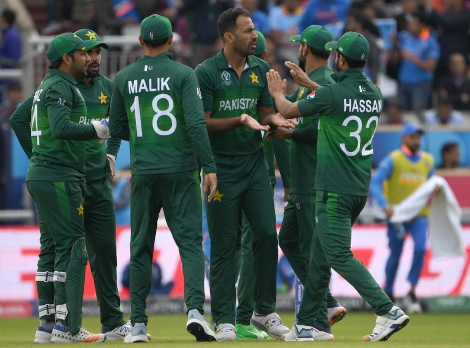 Pakistan's Wahab Riaz celebrates with teammates after the dismissal of India's K.L. Rahul. PHOTO: AFP