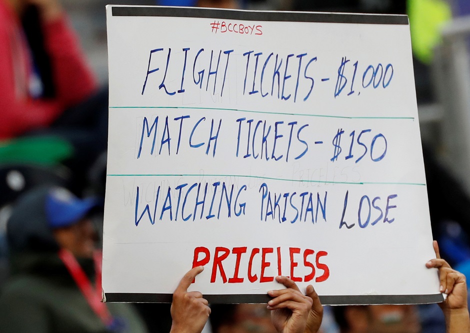 An Indian fan holds up a banner during the match. PHOTO: REUTERS