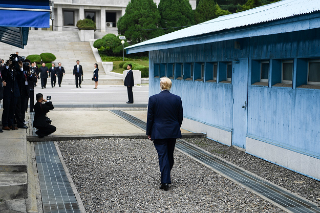 US President Donald Trump walks towards the Military Demarcation Line that divides North and South Korea, for a meeting with North Korea's leader Kim Jong Un, in the Joint Security Area (JSA) of Panmunjom in the Demilitarized zone (DMZ) on June 30, 2019. PHOTO: AFP