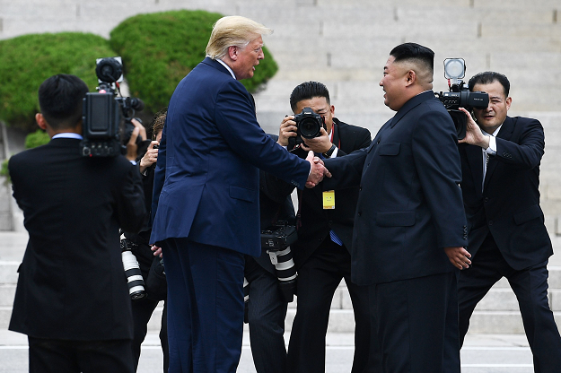 North Korea's leader Kim Jong Un shakes hands with US President Donald Trump north of the Military Demarcation Line that divides North and South Korea, in the Joint Security Area (JSA) of Panmunjom in the Demilitarized zone (DMZ) on June 30, 2019. PHOTO: AFP