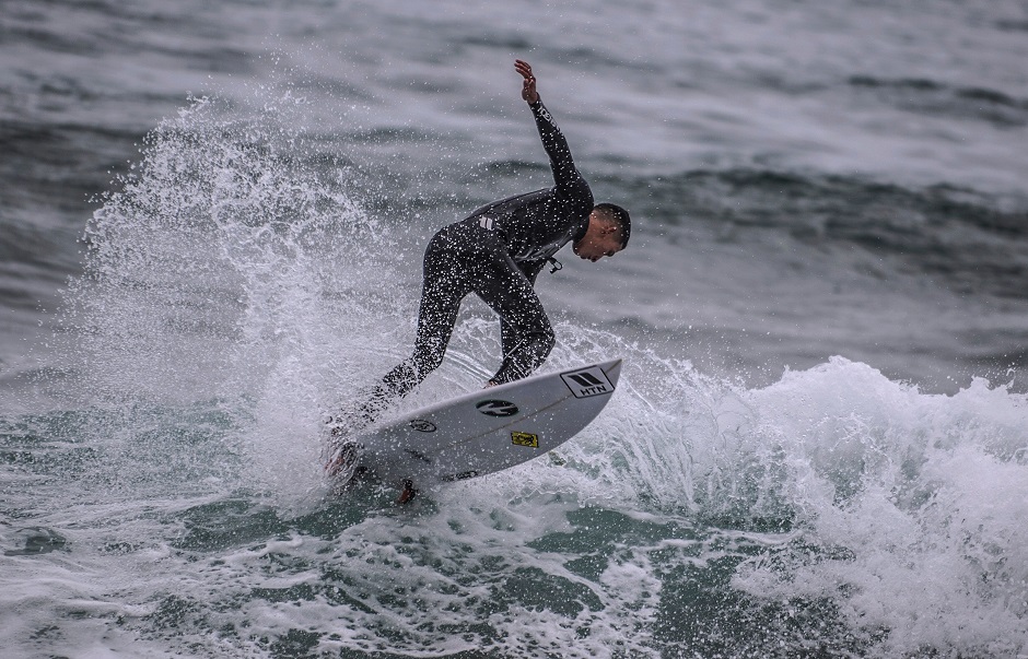 A surfer rides waves at Caplina beach in Lima. It was the ancient inhabitants of Peru the first to ride waves. PHOTO: AFP